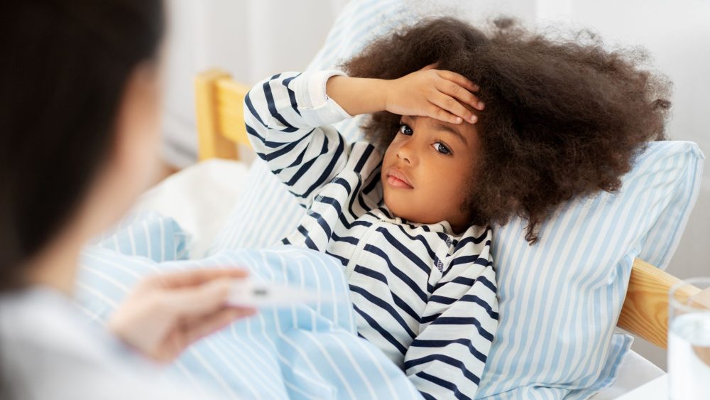 unwell little black girl in bed