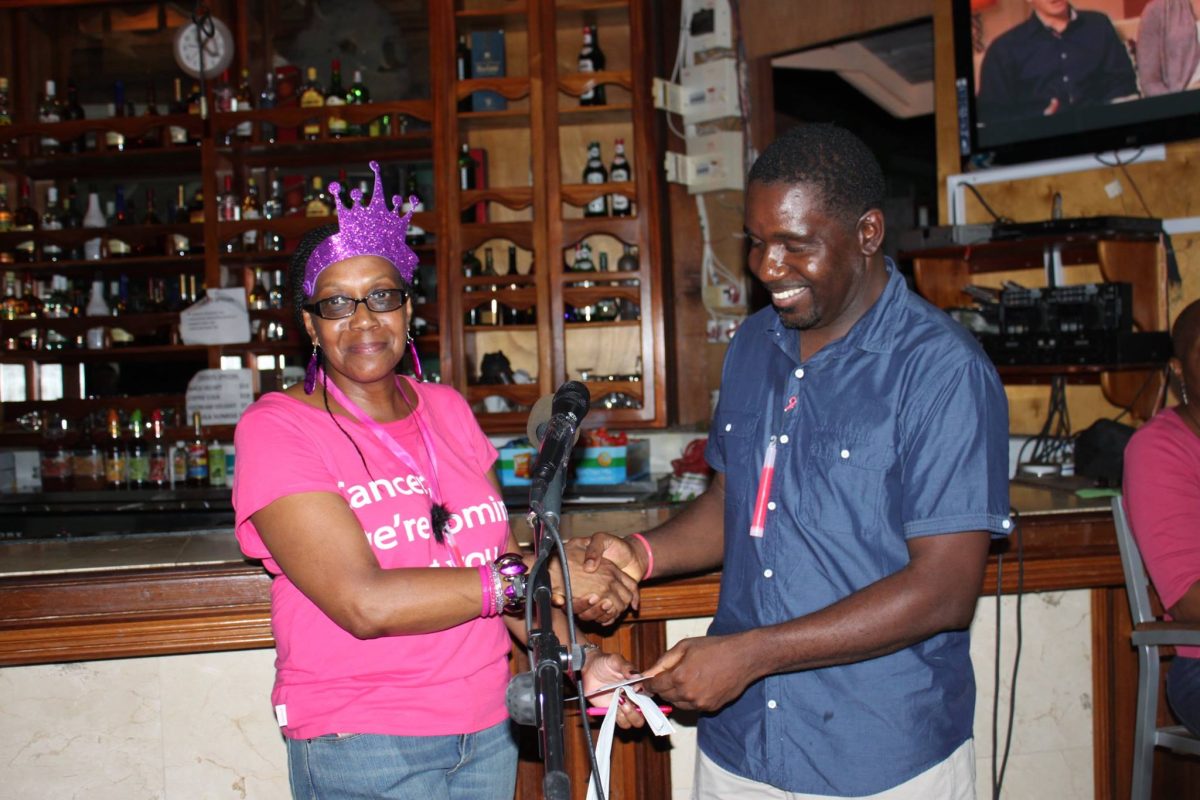 Sonia Charles, owner of Caribscan, the main sponsor of the Pink Ribbon Charity gives Dr Ronnie Samuel of Belmont Clinic Antigua a cheque of EC$9,000 which will allow 60 women from Montserrat to get free mammograms on Saturday, October 11, 2014 at The Lyme in Brades. (Goldenmedia Photo)