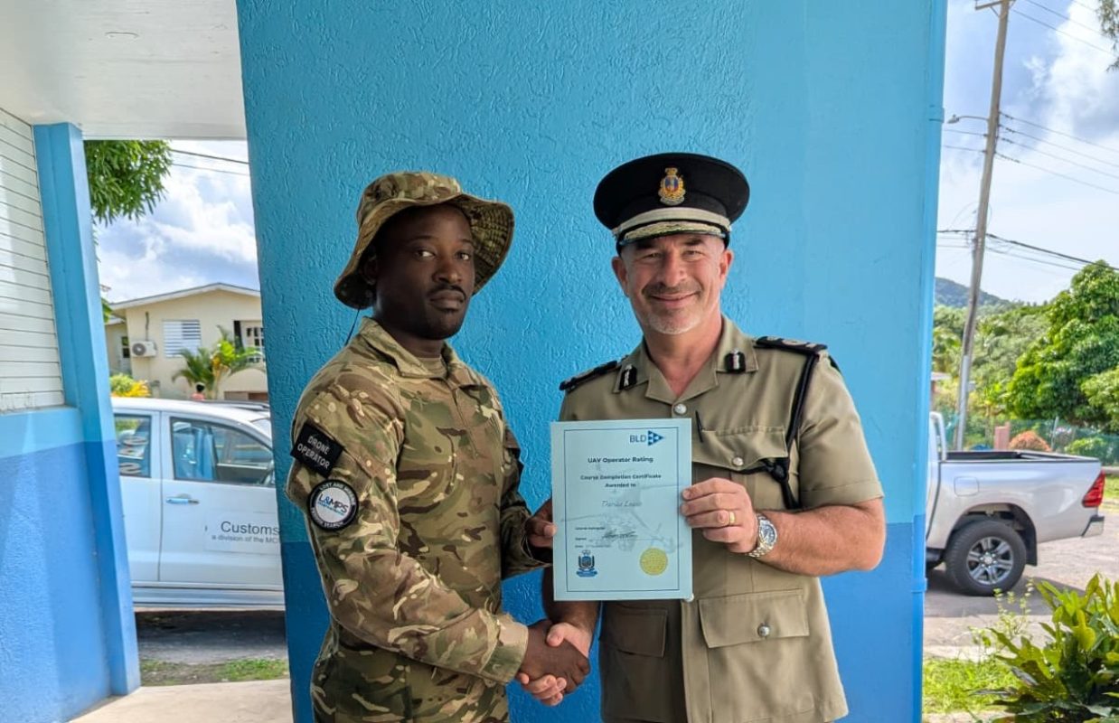 RMDF Lance Corporal Darius Lewis receives his certificate of completion from Commissioner Mark Payne.
