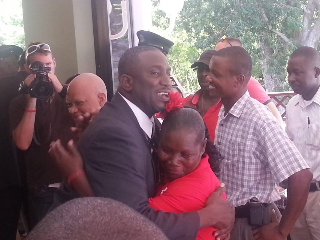 Premier Donaldson Romeo embraces a supporter after his swearing in ceremony at Government House on Friday, September 12, 2014.