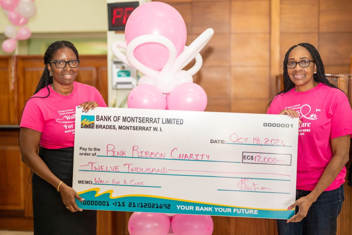 Bank of Montserrat Ltd's Operations manager Kathyan Fenton hands over their sponsorship check to Sonia Charles, President of the Pink Ribbon Charity.