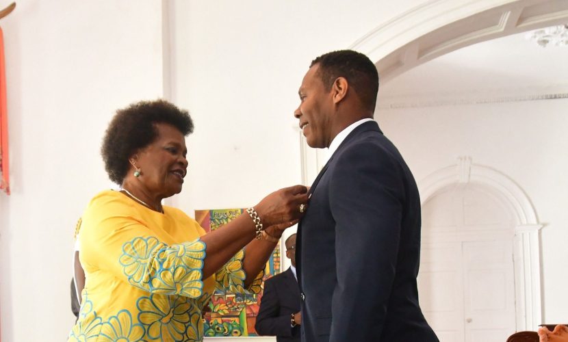 Derek Browne receives the Pride of Barbados Award from Dame Sandra mason, Pre (Yvonne Weekes photo)