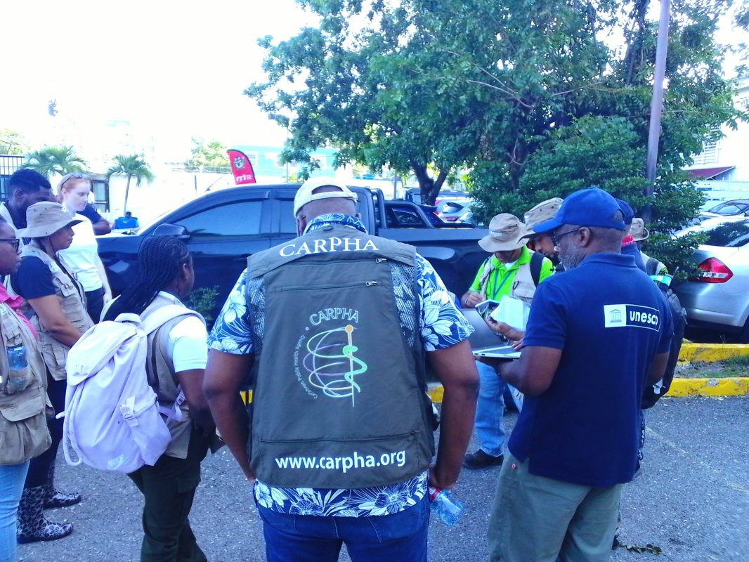 CARPHA Director and Incident Commander, Dr. Horace Cox (wearing CARPHA vest -centre) huddles in a
team briefing at ODPEM headquarters ahead of deployment.