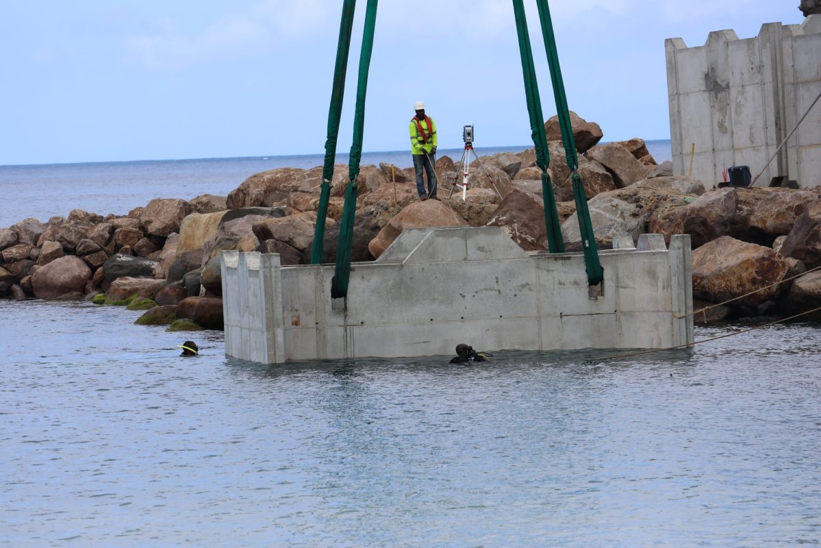 A caisson being placed in Little Bay as part of the port construction project.